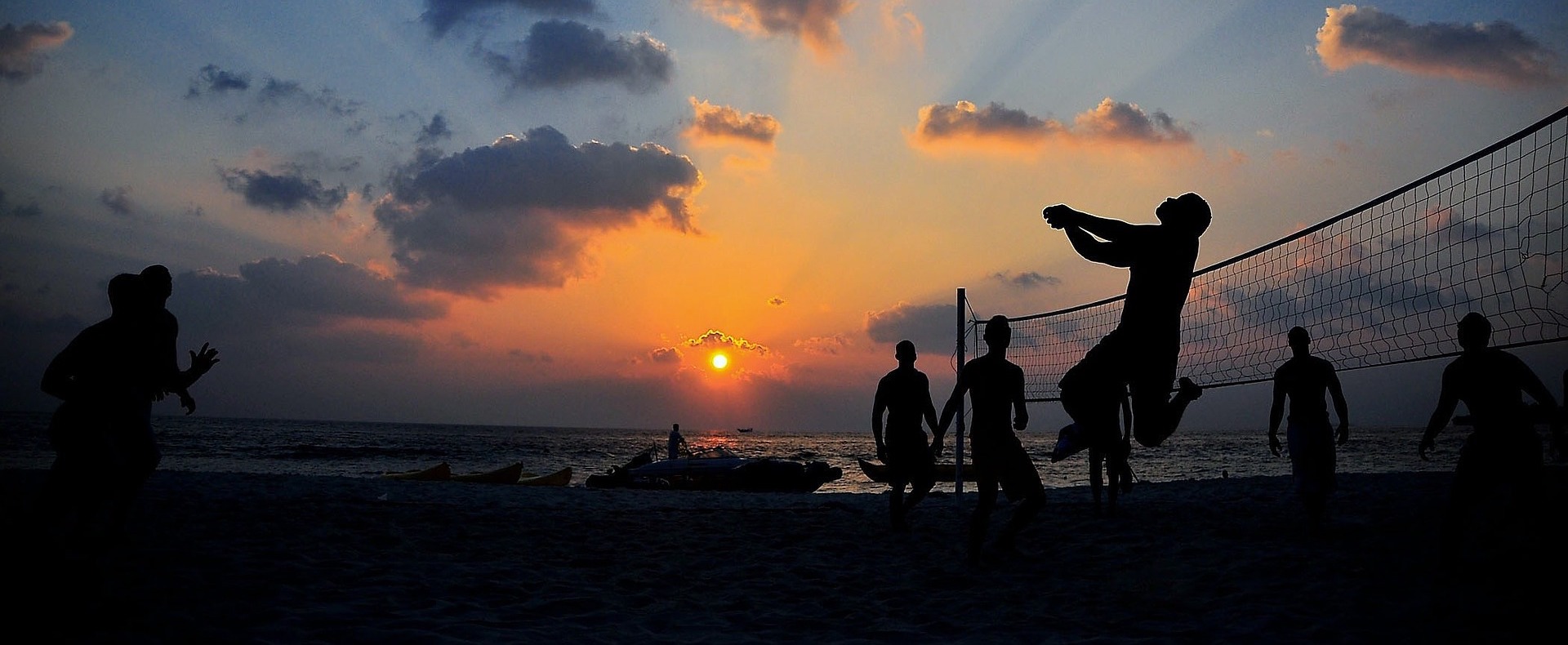 Beach volleyball at sunset